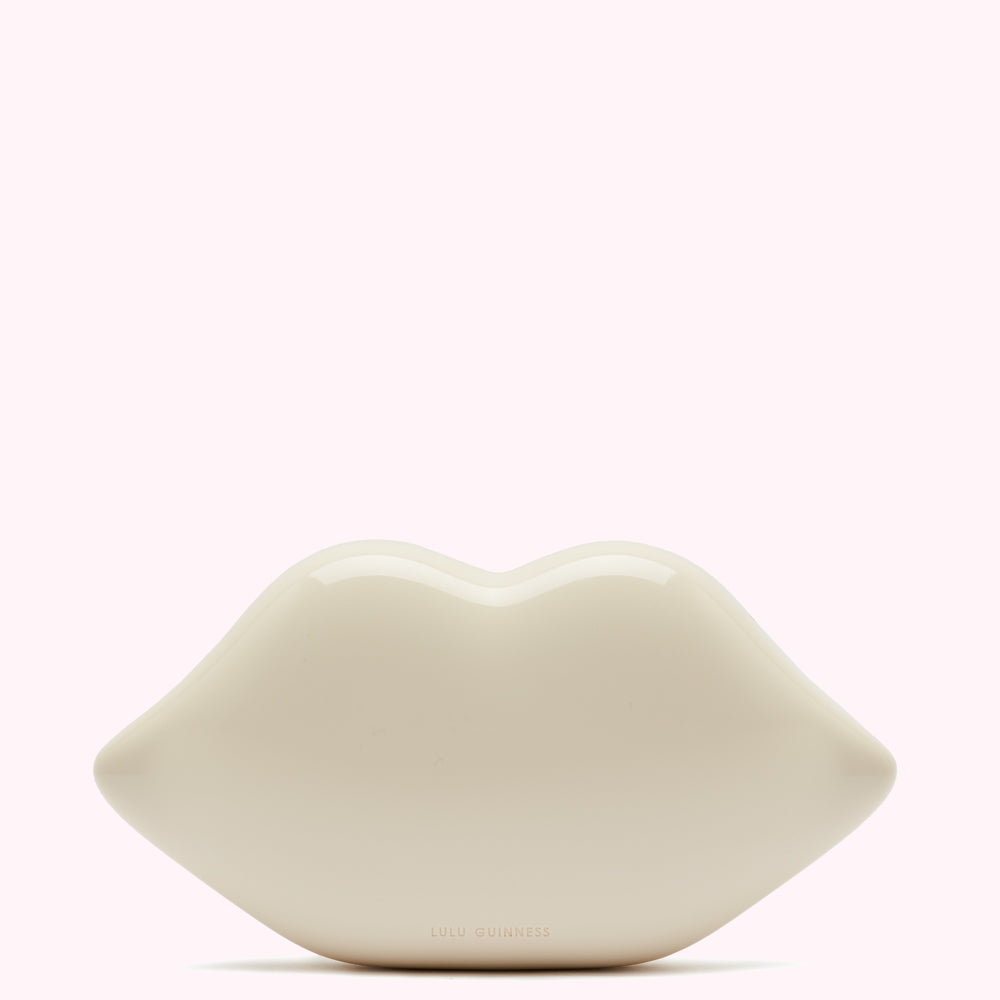 Off-white Lulu Guinness lip-shaped clutch bag against a white background.
