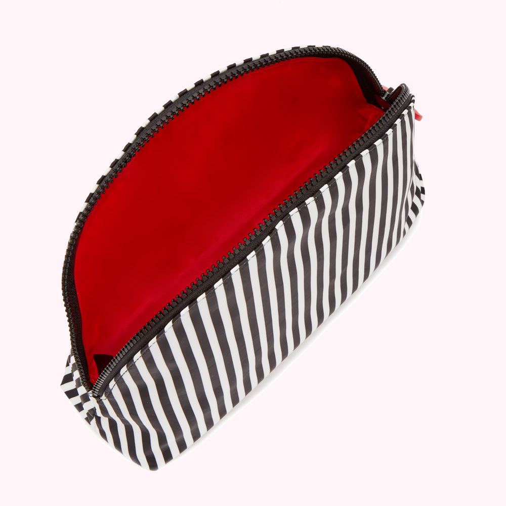 Black and white striped makeup bag with red interior, open to reveal empty interior.