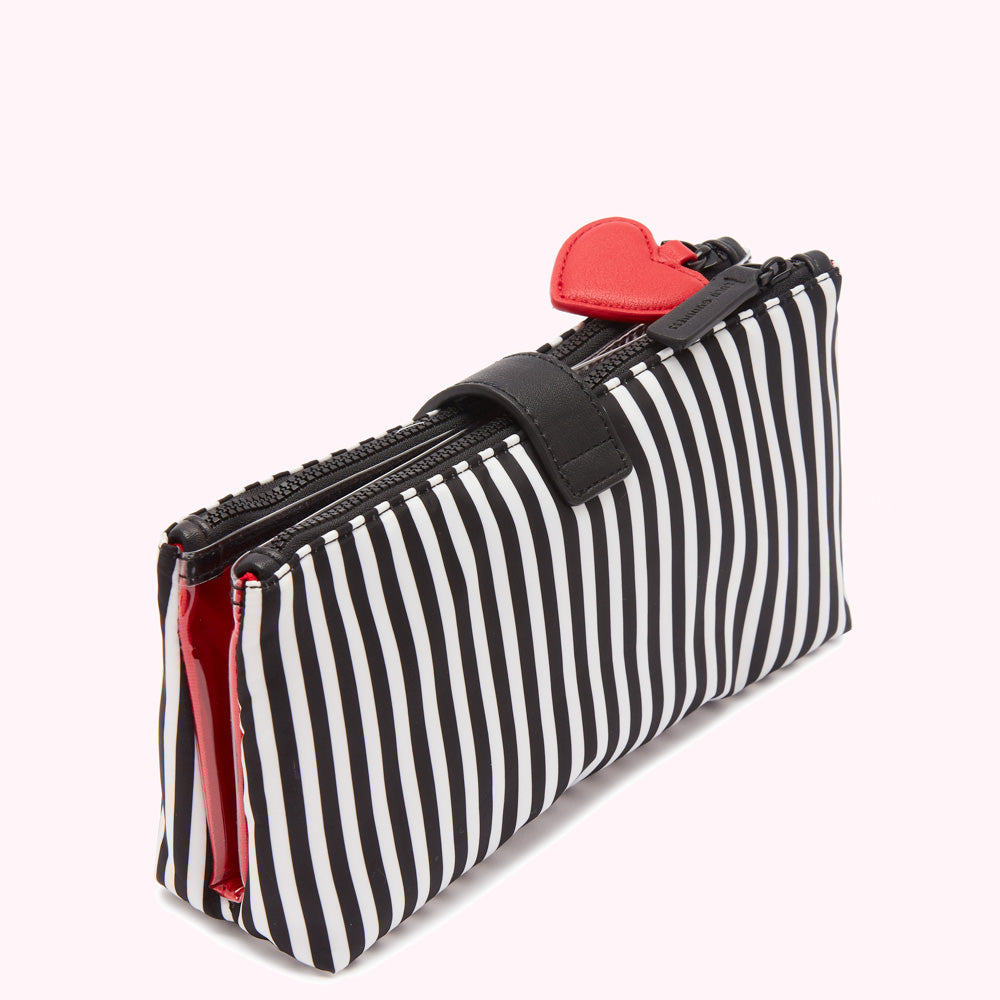 Black and white striped double zippered cosmetic bag with a red heart charm.
