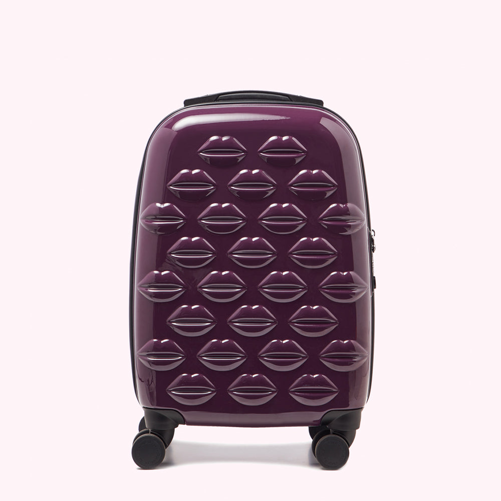 Purple suitcase with lips pattern.
