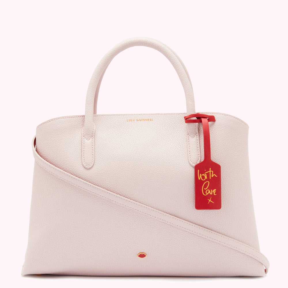 Pale pink Lulu Guinness satchel with a red leather "With Love" tag.

