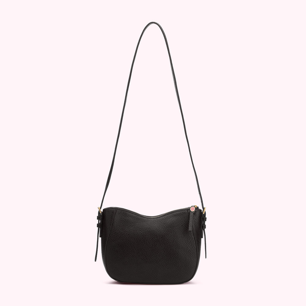 Black leather crossbody bag against a white background.
