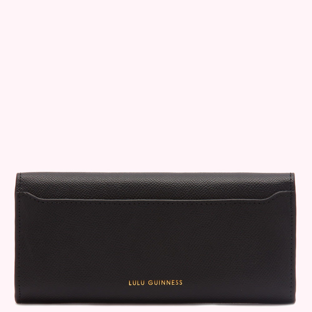 Black Lulu Guinness wallet on white background.
