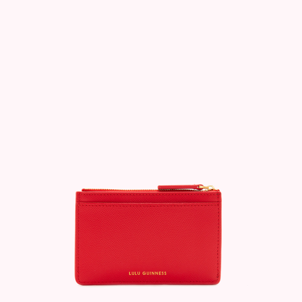 Red leather cardholder with gold zipper and Lulu Guinness logo.
