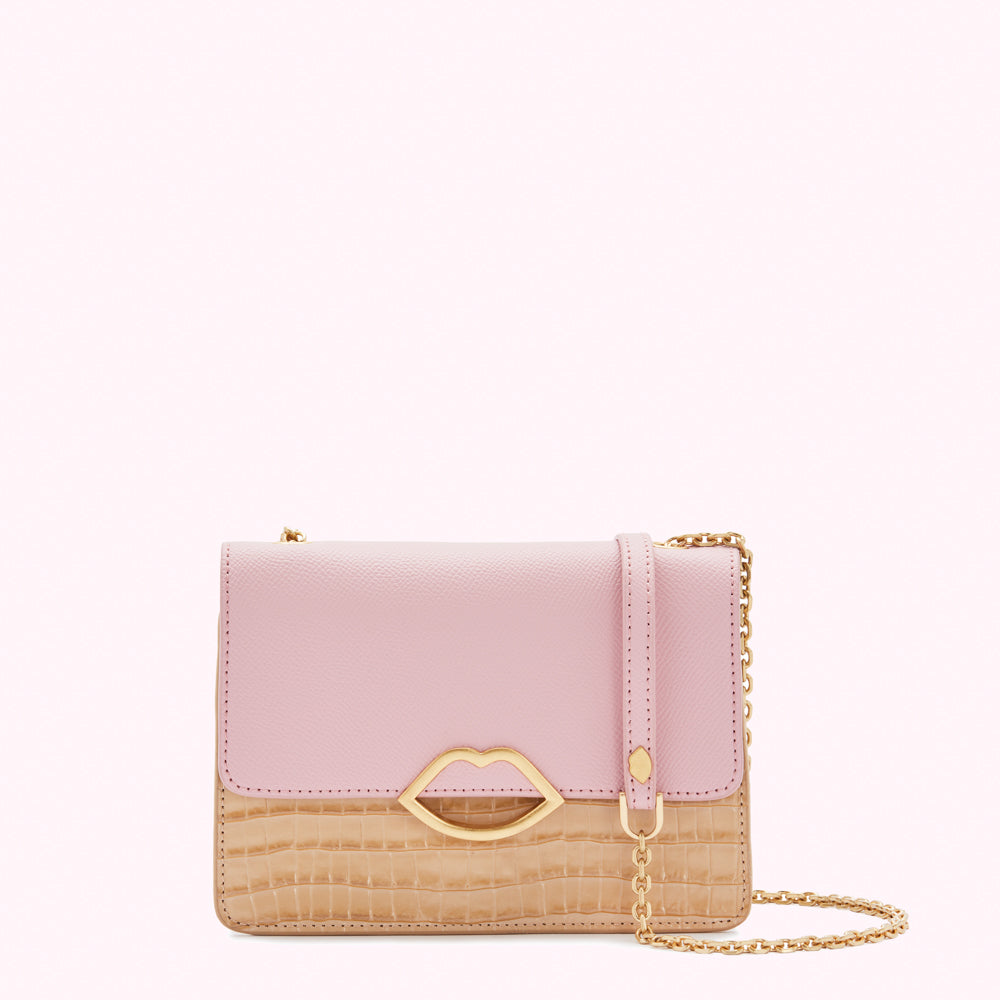 Pink and beige crossbody bag with gold lip-shaped clasp and chain strap.
