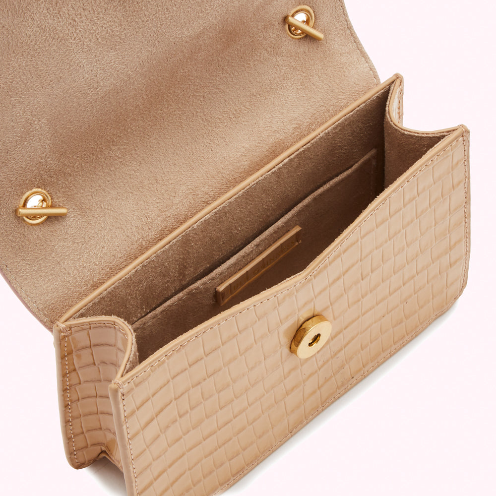 Beige crocodile-embossed leather handbag open to reveal its interior.