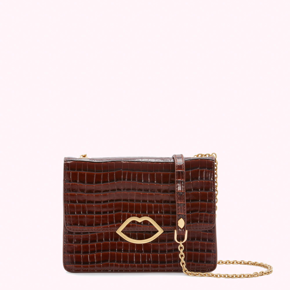 Brown crocodile-embossed leather crossbody bag with gold lip detail and chain strap.
