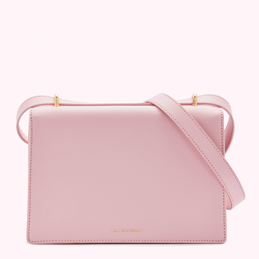 Pink leather Lulu Guinness crossbody bag with gold hardware.
