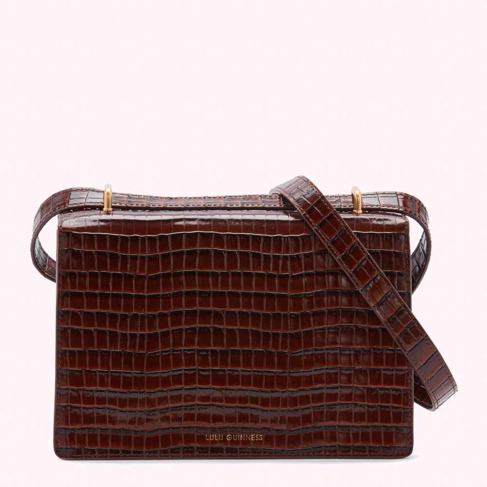 Brown Lulu Guinness crossbody bag with crocodile-embossed leather.
