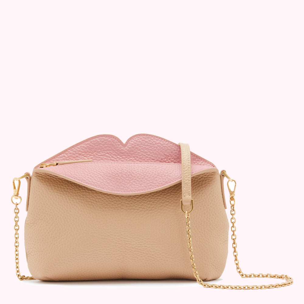 Beige and pink leather crossbody bag with a lip-shaped opening and gold chain strap.
