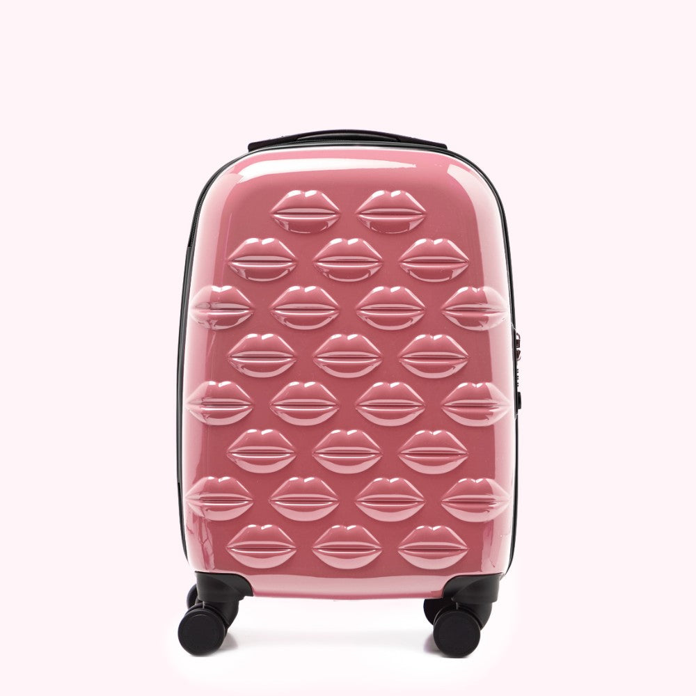 Pink carry-on suitcase with a lip print pattern.

