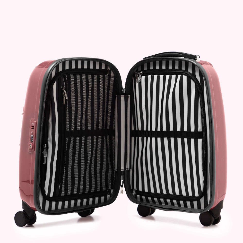 Open mauve suitcase with black and white striped lining.