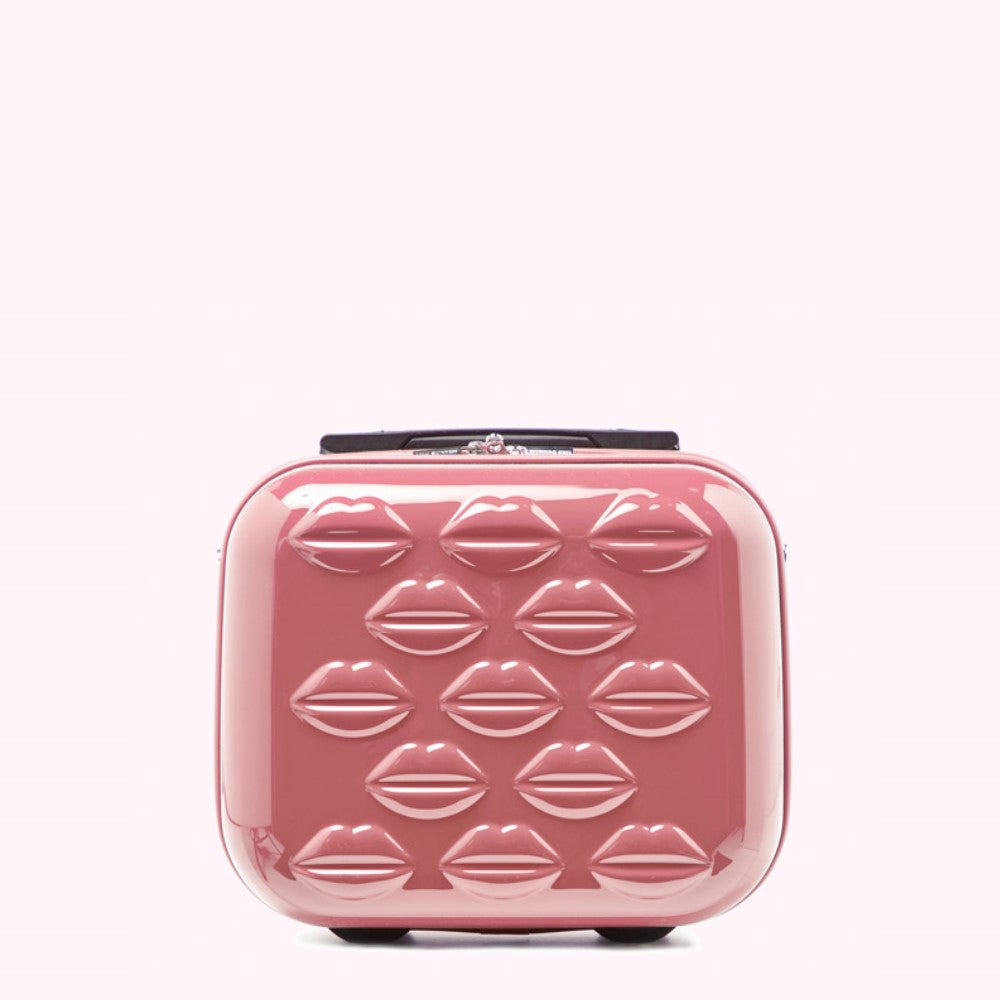 Pink rolling suitcase decorated with lip print.