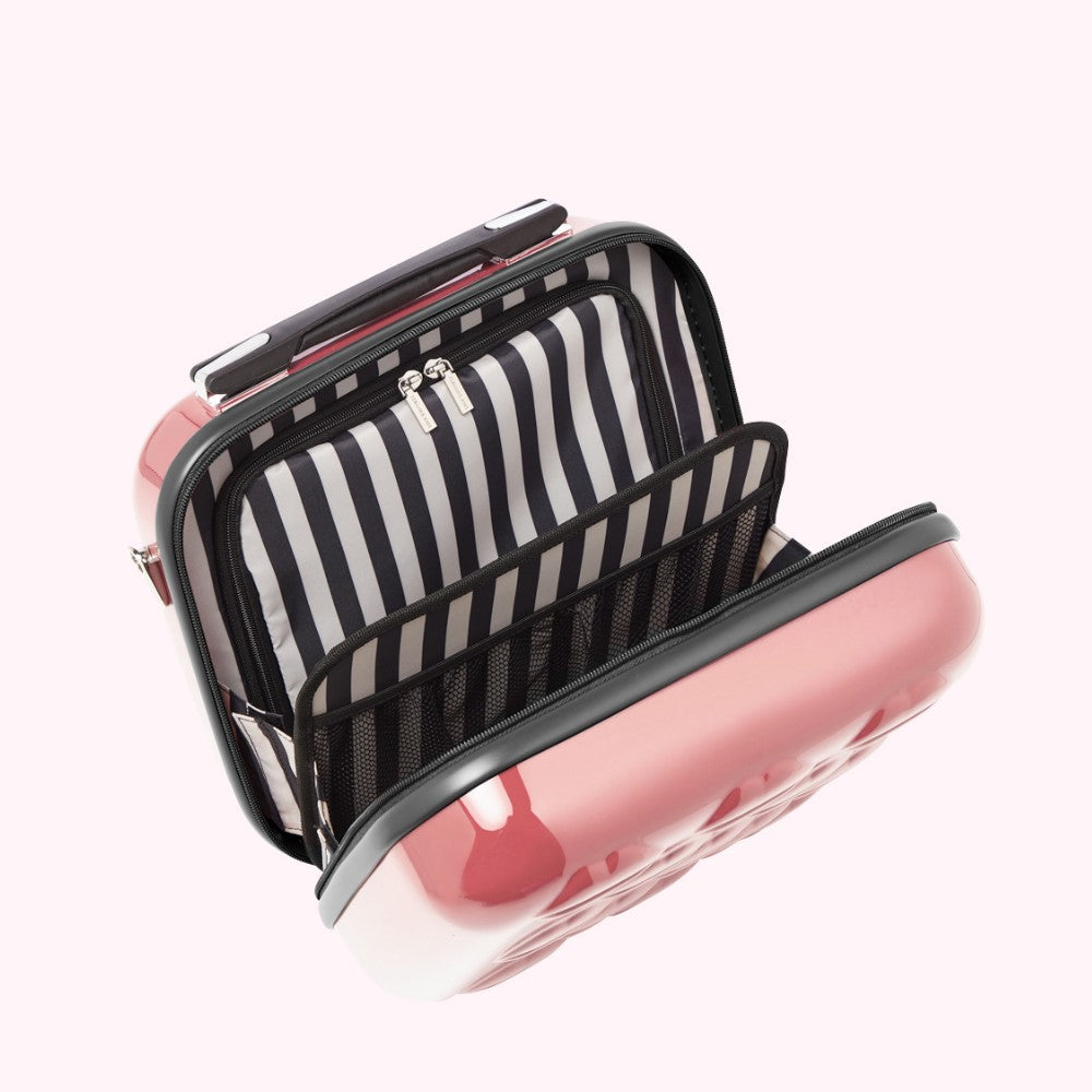 Open pink hard shell rolling makeup case with black and white striped interior lining and compartments.