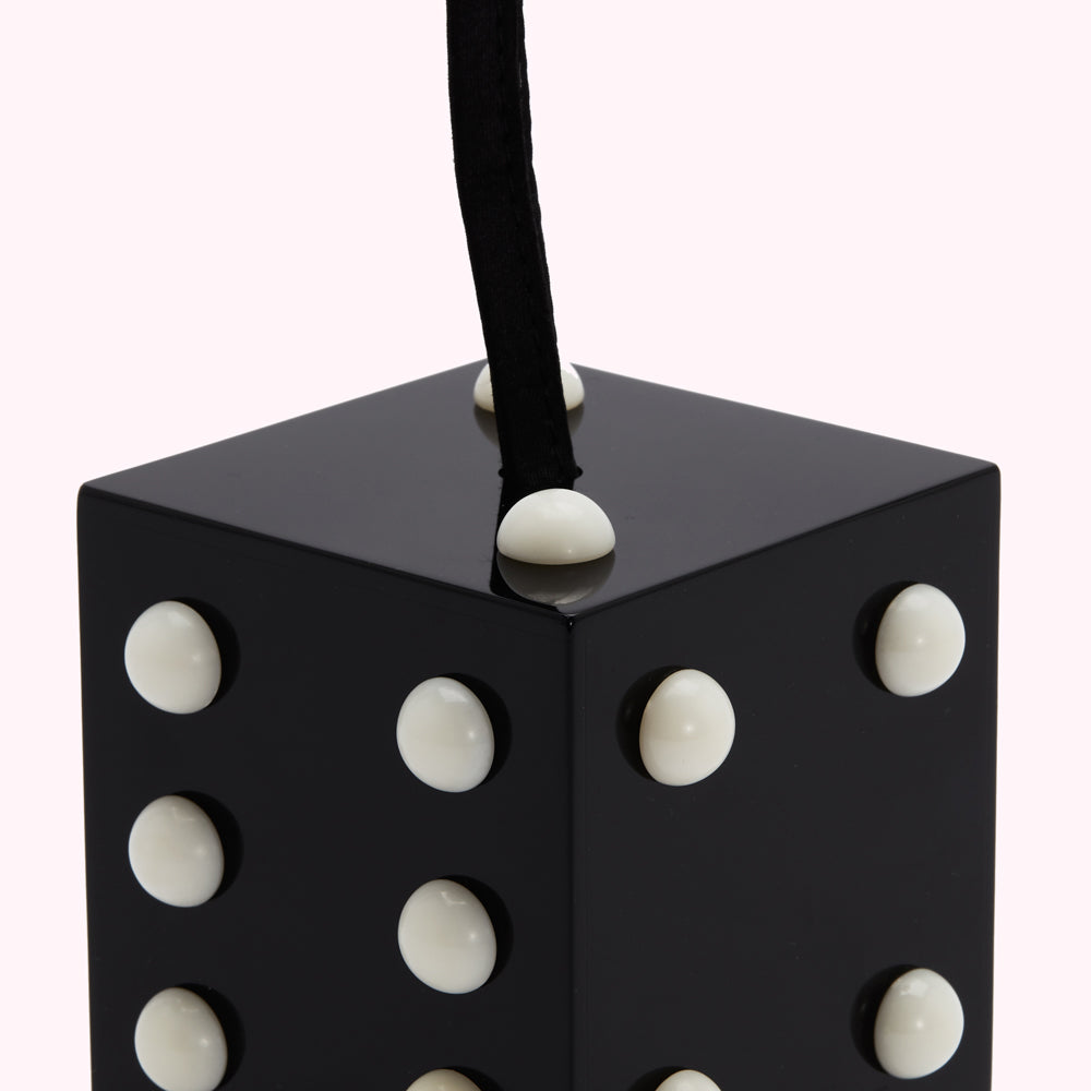 Black cube-shaped bag with white dots and a black handle.
