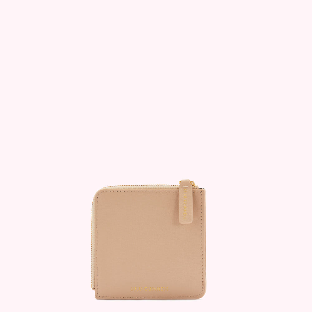 A light beige zipped coin purse with the brand name subtly embossed on the bottom.