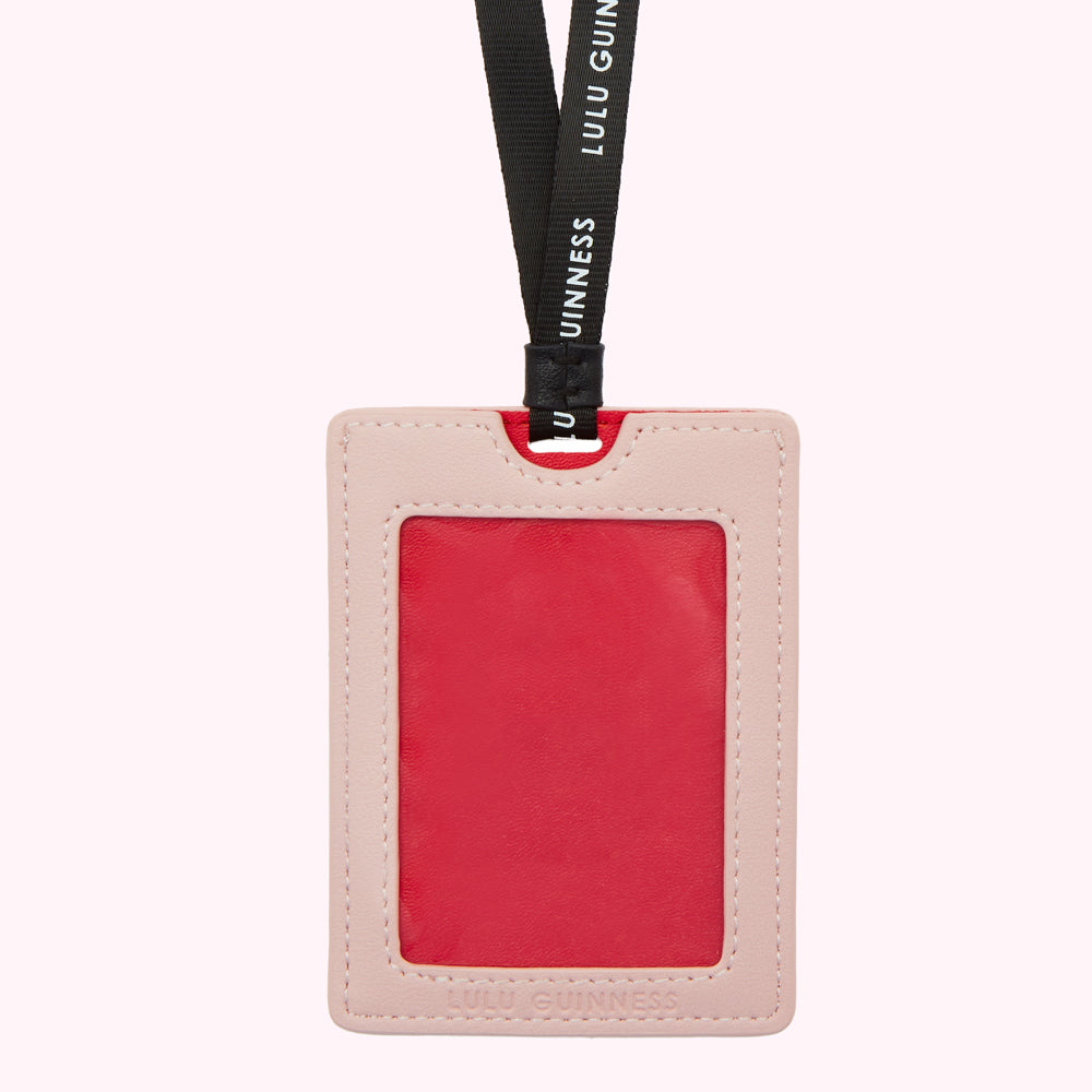 Pink and red Lulu Guinness ID holder with black lanyard.
