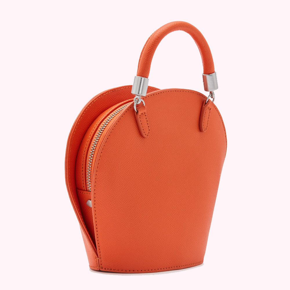 Orange leather handbag with silver top handles.

