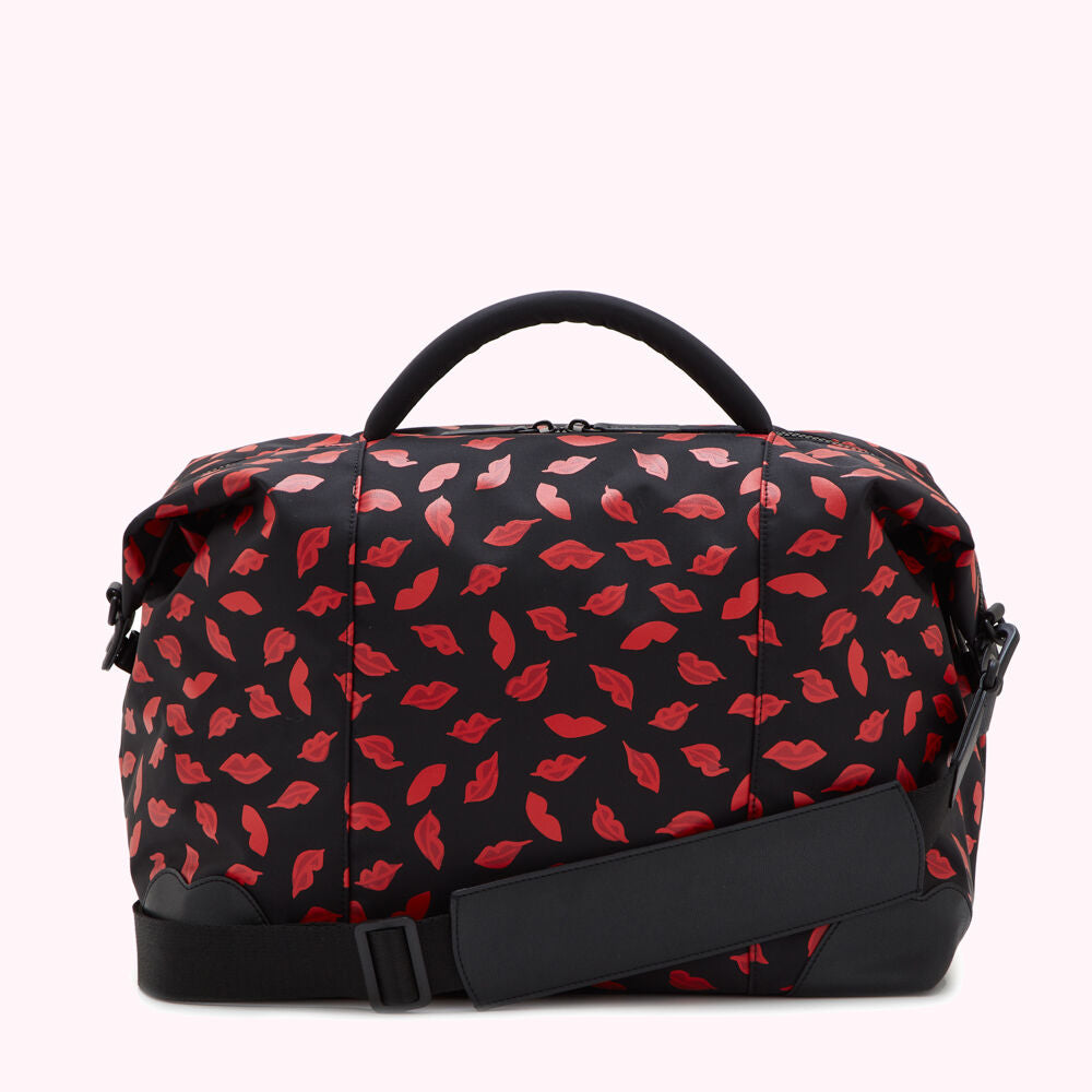 Black duffel bag with a red lips print.