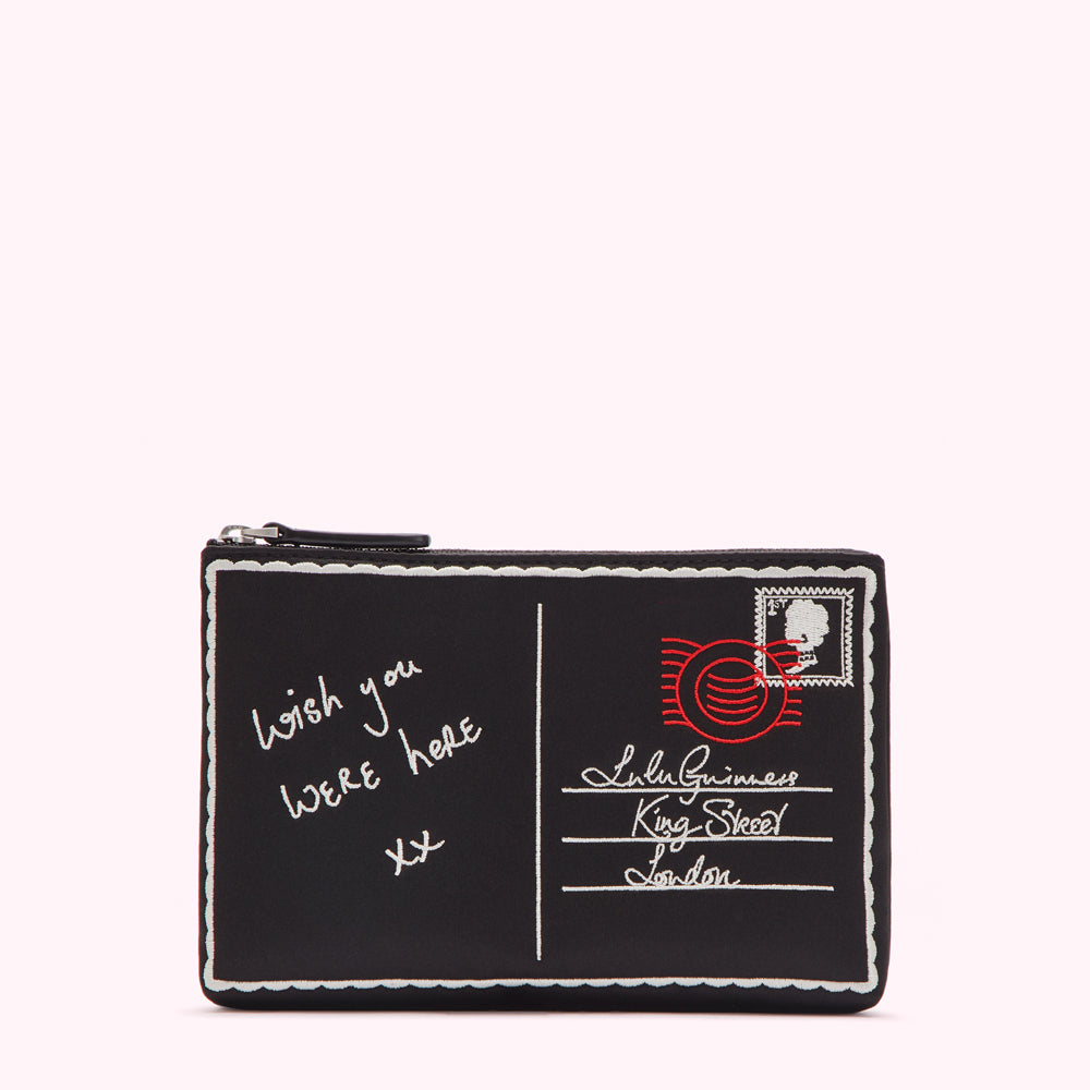 Black clutch designed as a postcard with embroidered text: "wish you were here xx," address and stamp.