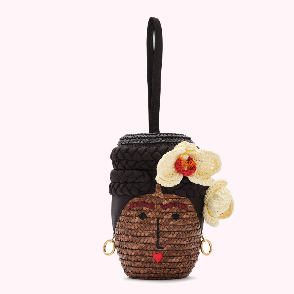 A brown woven purse shaped like a woman's face, adorned with crocheted flowers.
