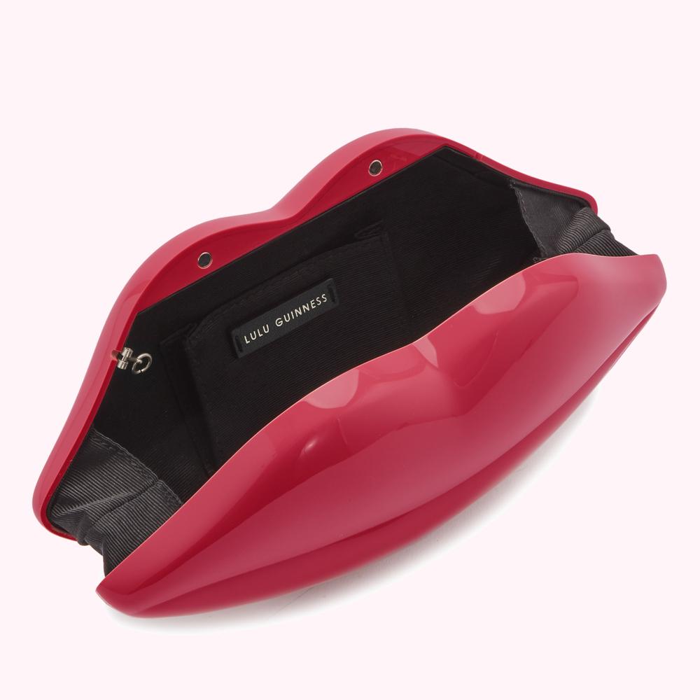 Open red Lulu Guinness lip-shaped clutch.
