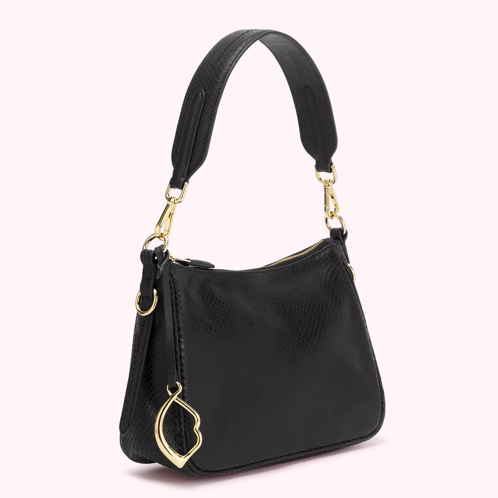 Black leather handbag with gold hardware and a small gold charm.
