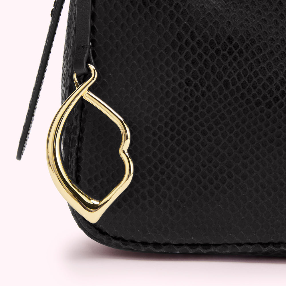Close-up of a black snakeskin textured handbag with a gold-coloured clasp.
