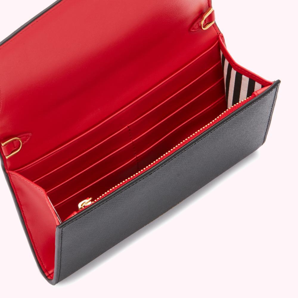 Open black leather wallet with red interior and gold zipper.
