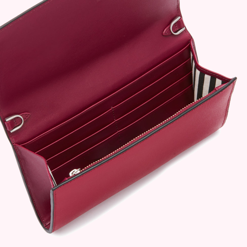 Open crimson leather wallet with multiple card slots and a shoulder strap.