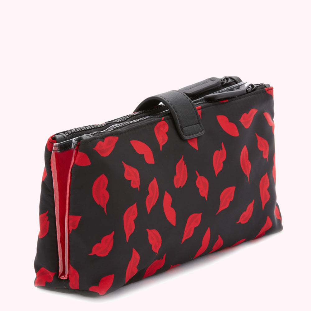 Black double zippered makeup bag with a red lips print.
