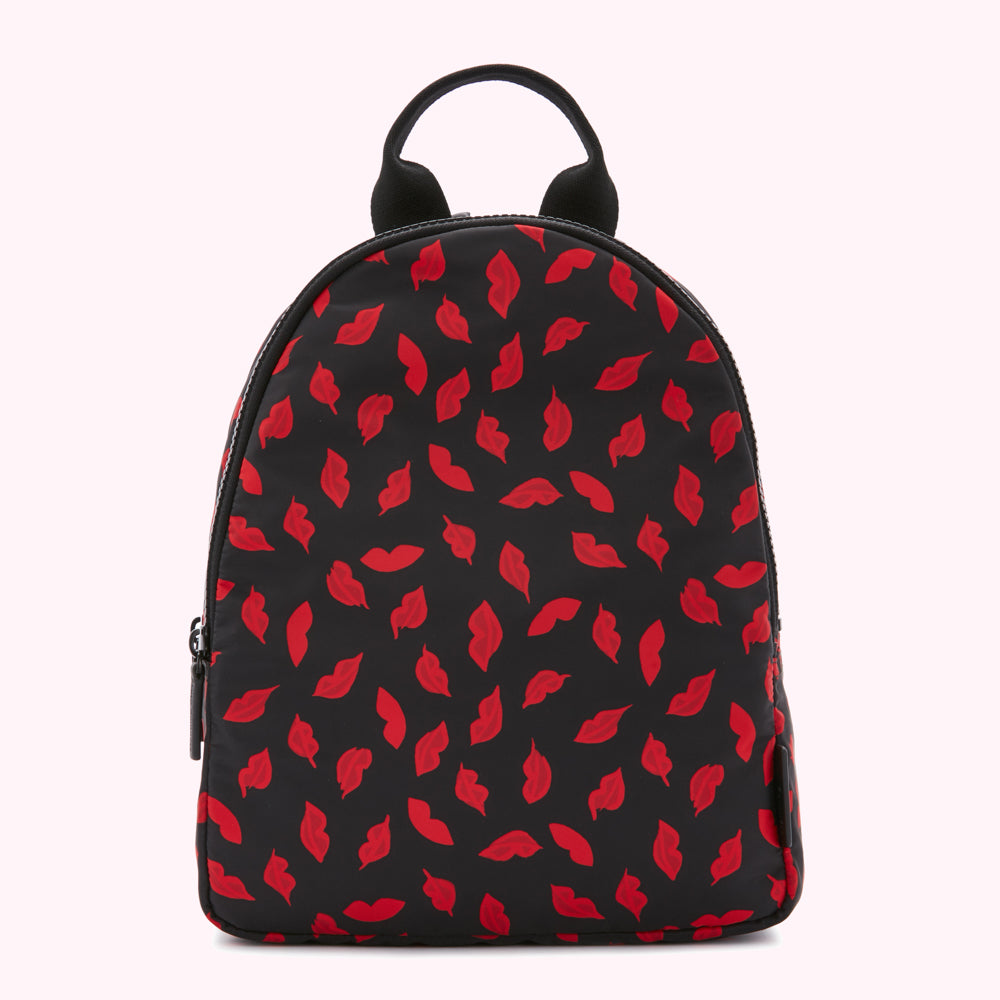 Black backpack with a red lips print.
