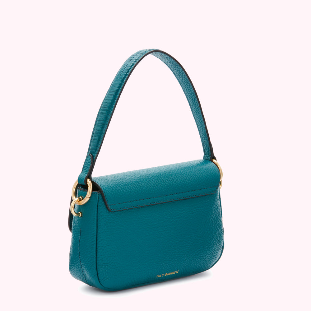 Teal Lulu Guinness crossbody bag with gold hardware, shown from the back.
