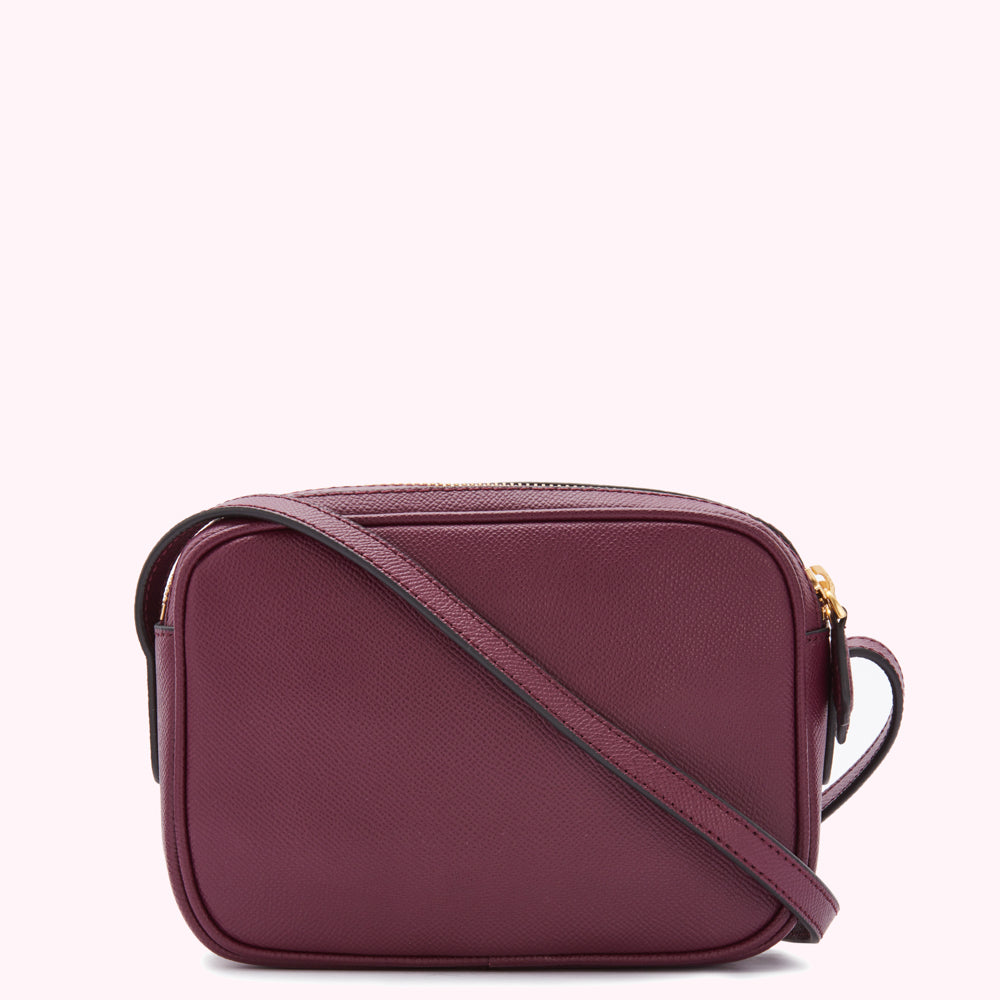 Burgundy rectangular crossbody bag with a gold zipper.
