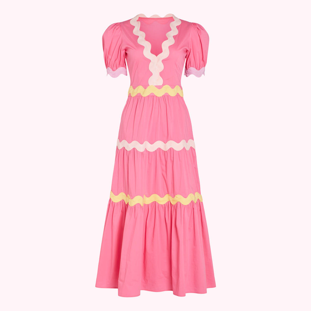 Pink midi dress with yellow and light pink scalloped trim.
