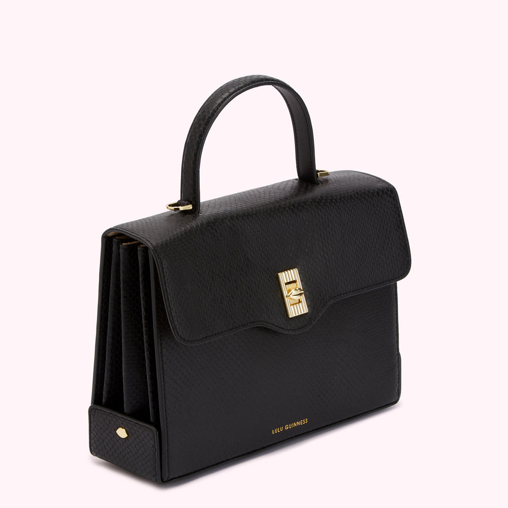 Black Lulu Guinness snakeskin handbag with gold clasp and handle.
