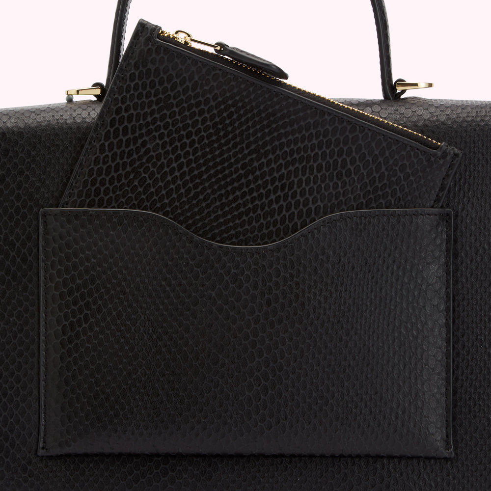 Close-up of a black snakeskin handbag with a zippered pouch and an additional slip pocket.

