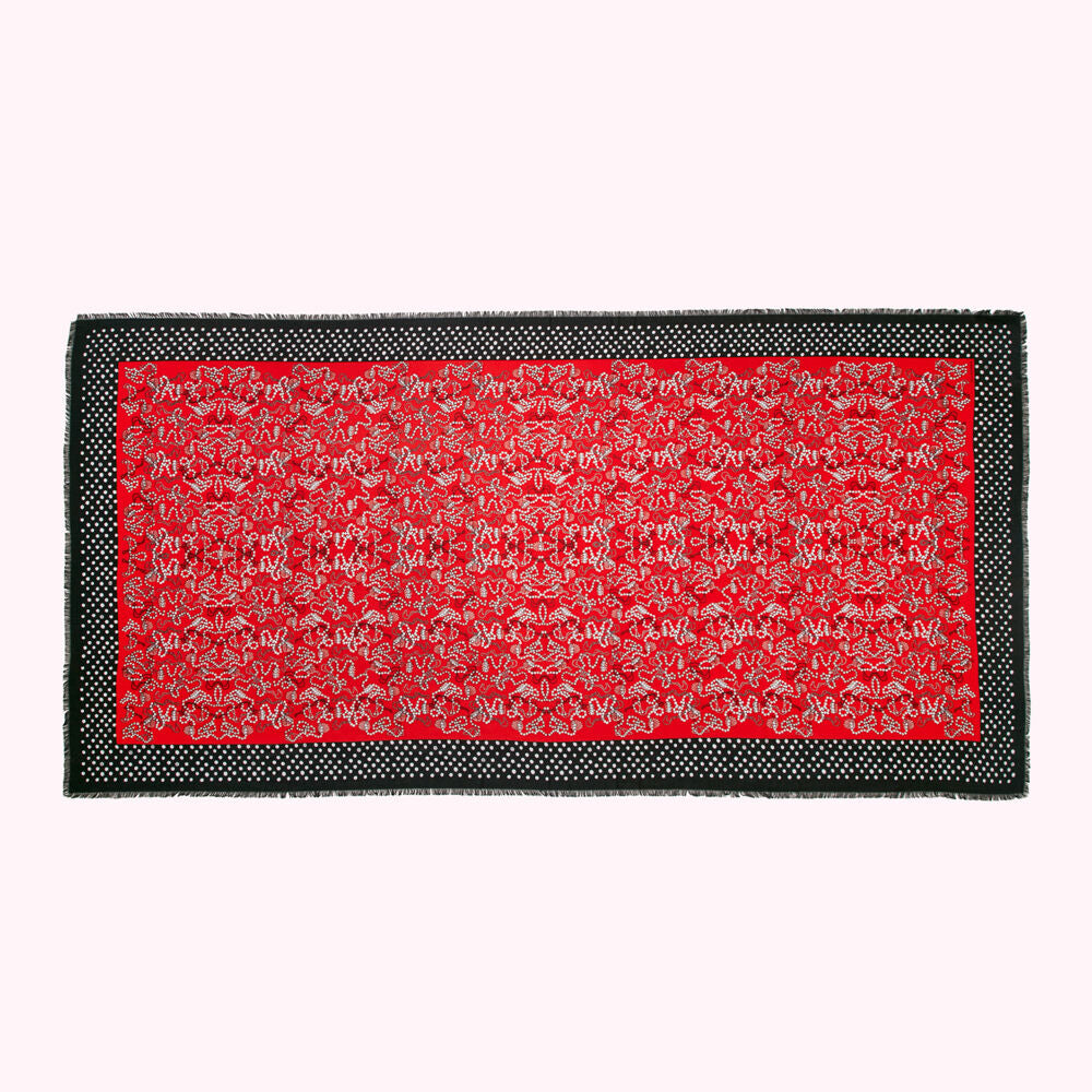 Red scarf with black and white pattern.