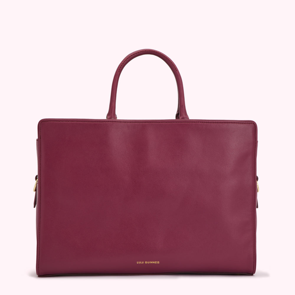 A dark burgundy Lulu Guinness tote bag on a white background.

