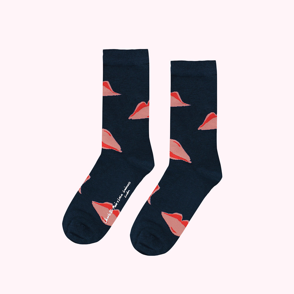 Pair of dark blue socks with a pattern of pink lips.