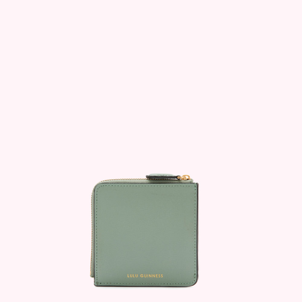 Sage green leather zip-around wallet by Lulu Guinness on a white background.
