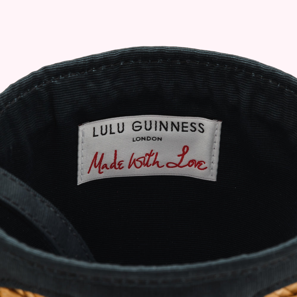 Close-up of a dark teal Lulu Guinness London bag's interior, showing a label that reads "Made With Love".