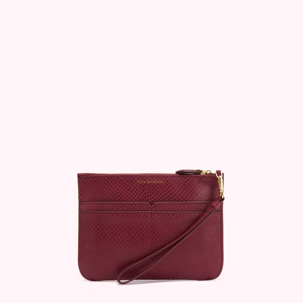 A burgundy snakeskin-textured clutch with a gold zipper and wrist strap.