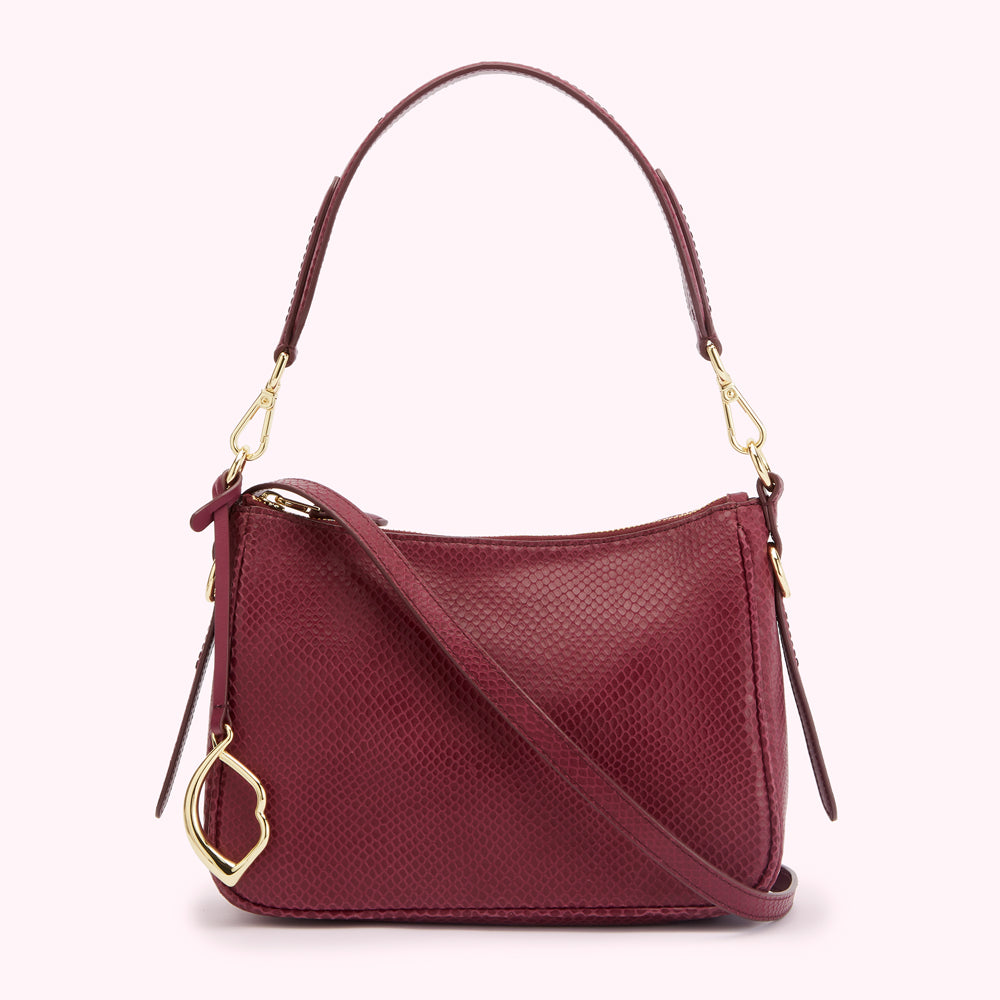 Burgundy snakeskin-textured crossbody bag with gold hardware.
