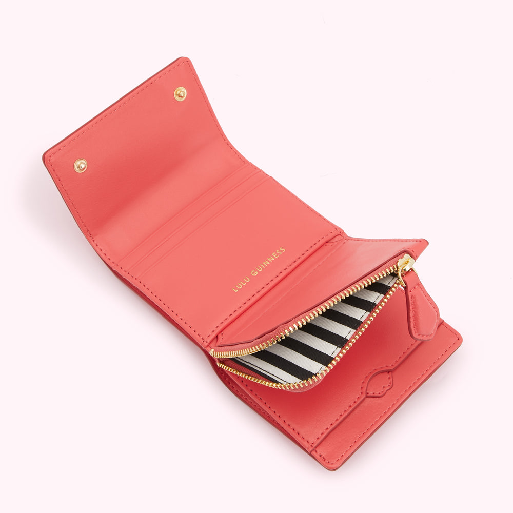 Coral pink Lulu Guinness wallet open to show the interior and zipped coin compartment.