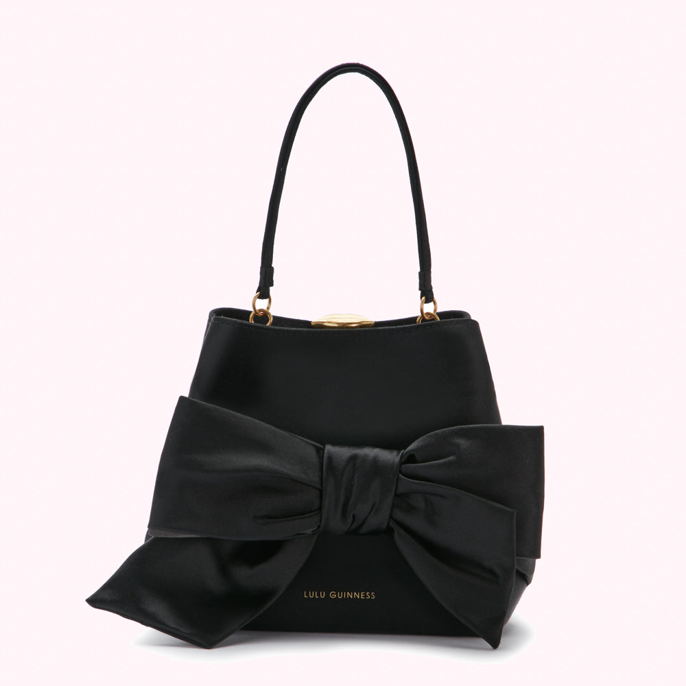 Black Lulu Guinness satchel bag with large black satin bow.
