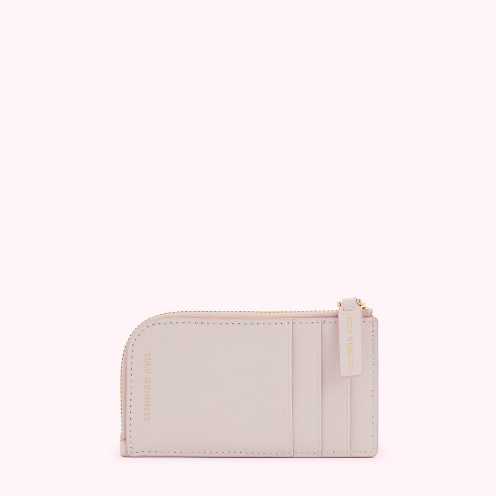 A pale pink Lulu Guinness zip-around cardholder.
