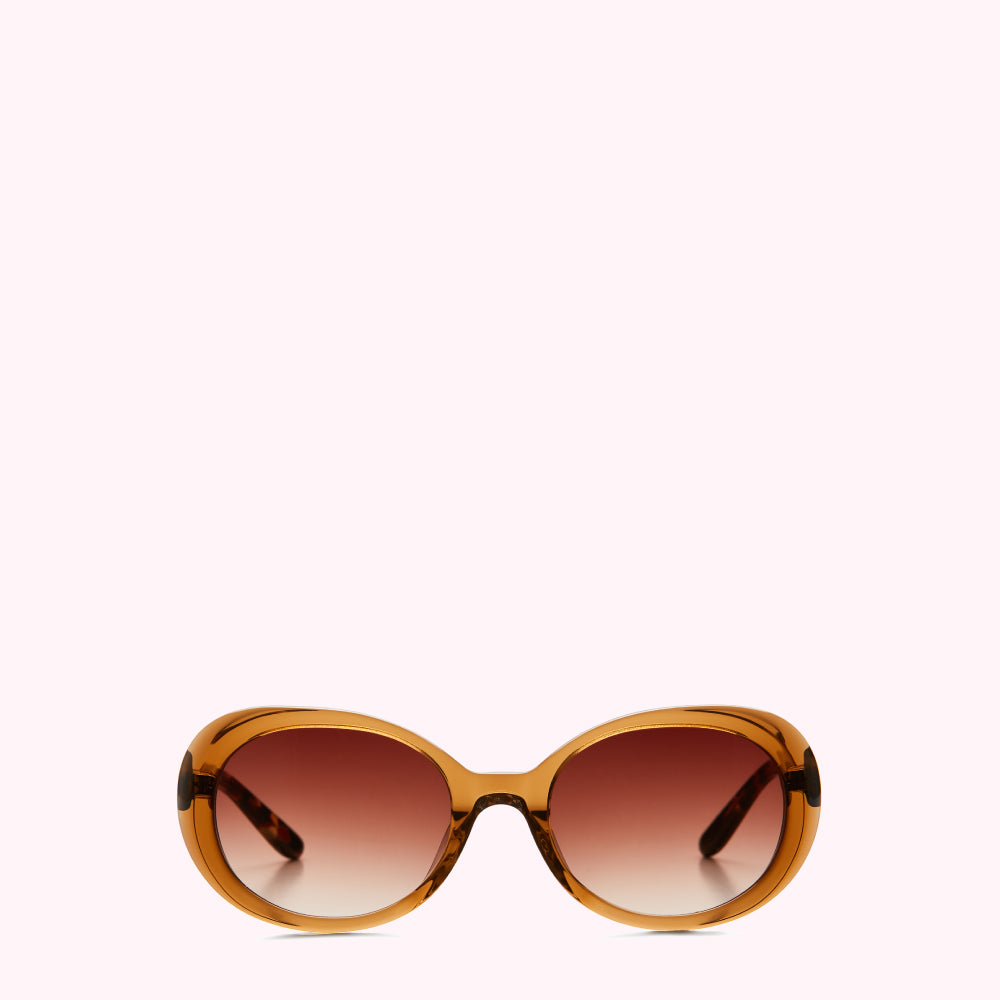 Amber-toned oval sunglasses with brown gradient lenses against a white background.
