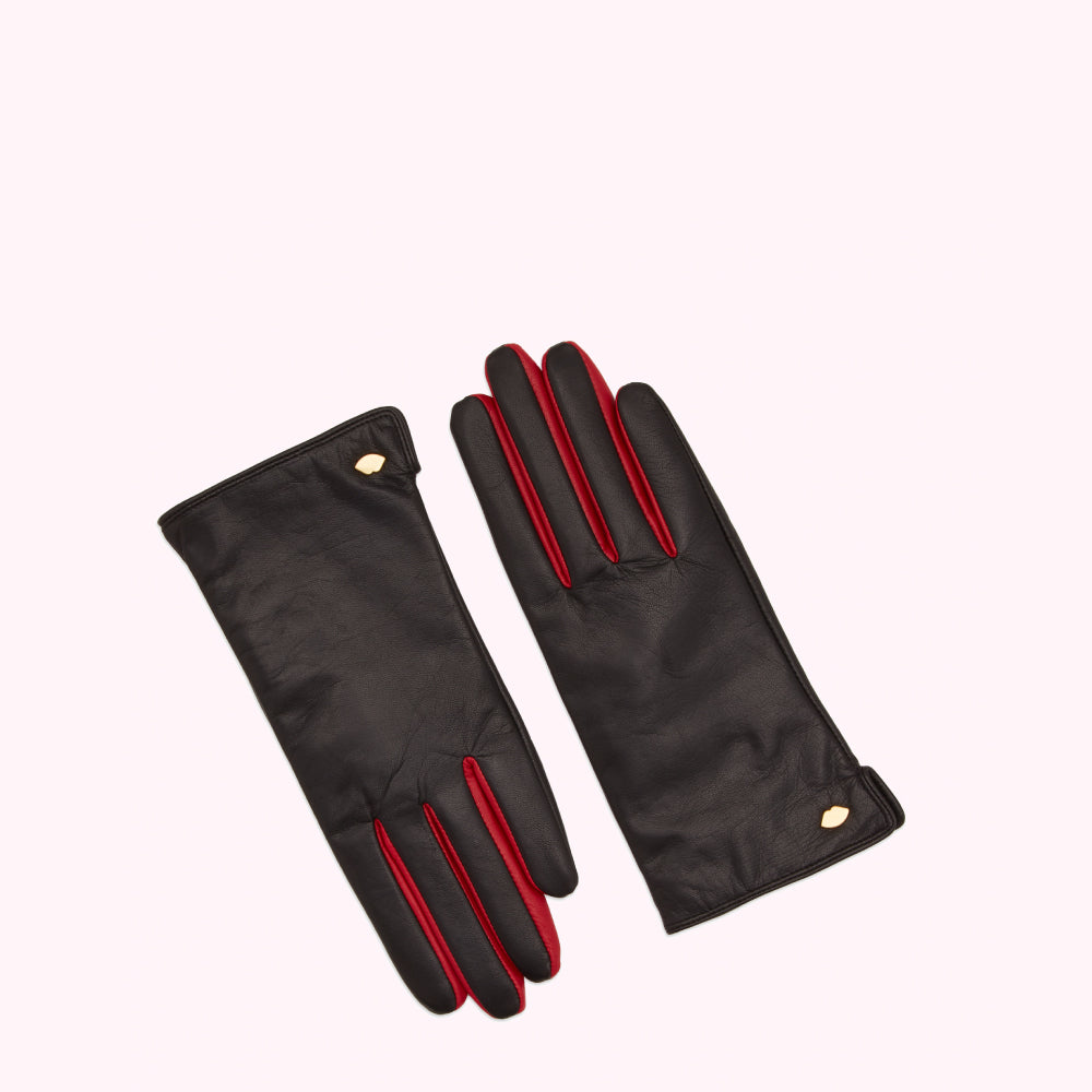 Pair of black leather gloves with red accents and gold detailing against a white background.
