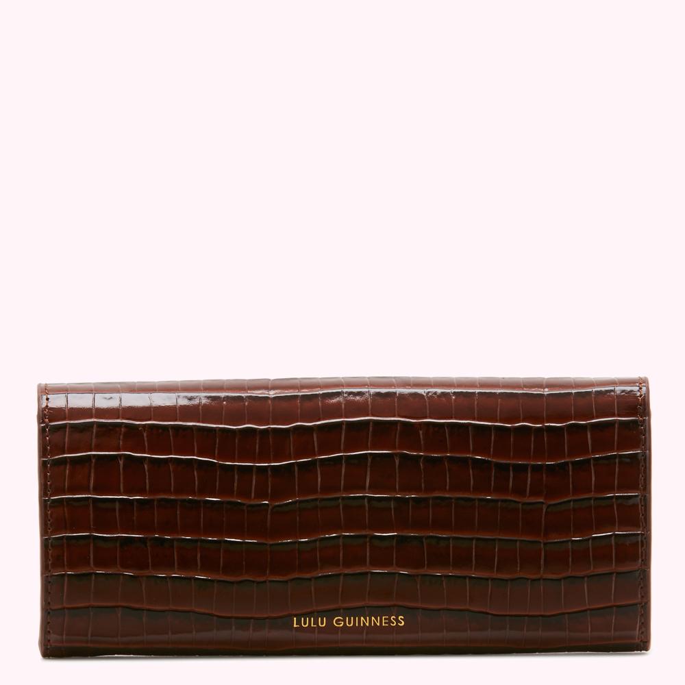 Brown leather Lulu Guinness wallet with crocodile texture.